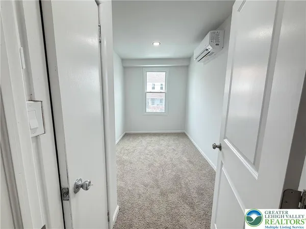 a view of hallway with window and stairs