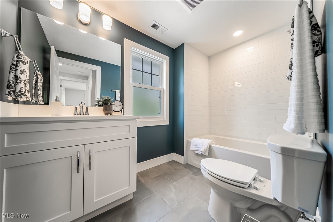3817 Summit Park Road Cleveland Heights, OH 44121 - Photo 16 of 29 Bathroom with toilet, ceramic tile flooring, vanity, and shower / tub combo with tile surround