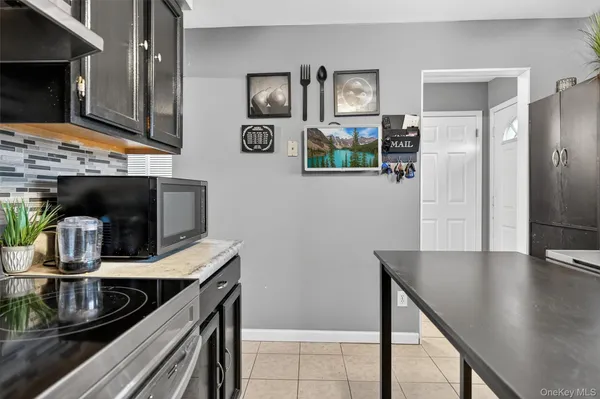 a kitchen with stainless steel appliances granite countertop a refrigerator a stove and a sink with wooden floor