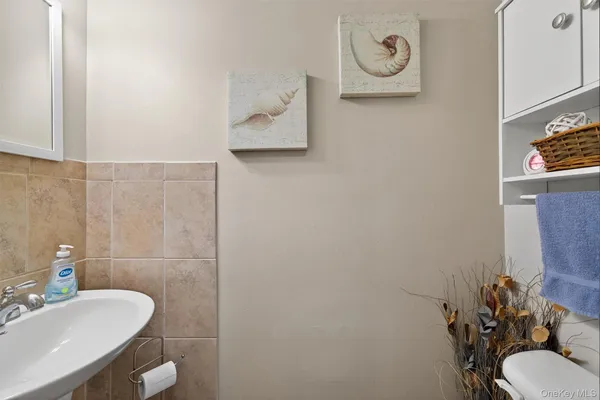 a bathroom with a sink toilet and a mirror