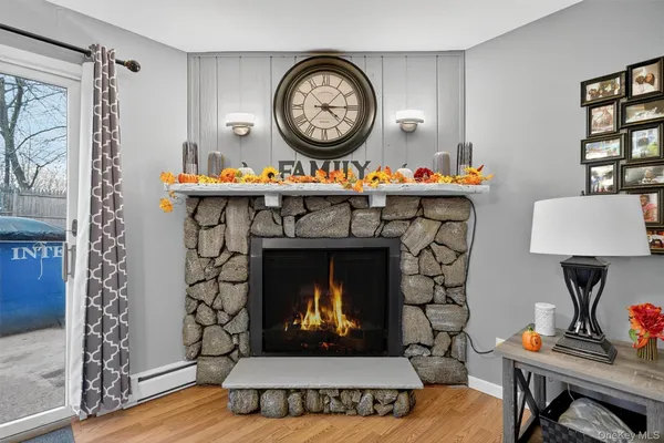 a living room with a clock and a fireplace