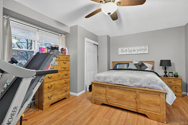 a bed room with a bed and a flat tv screen