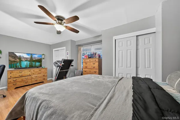 a bedroom with a large bed and a chandelier