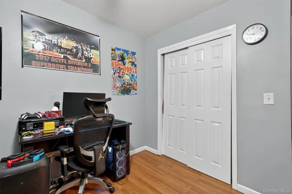 a view of a workspace with furniture and wooden floor