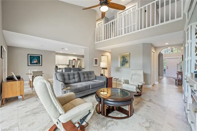 a living room with furniture a wooden floor and a chandelier