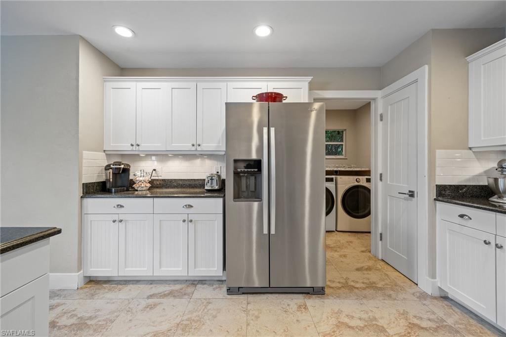5188 Mabry Drive Naples, FL 34112 - Photo 17 of 49 a kitchen with stainless steel appliances granite countertop a refrigerator and a stove top oven