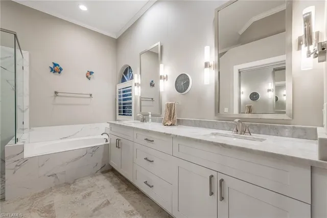 a bathroom with a granite countertop sink mirror and bathtub