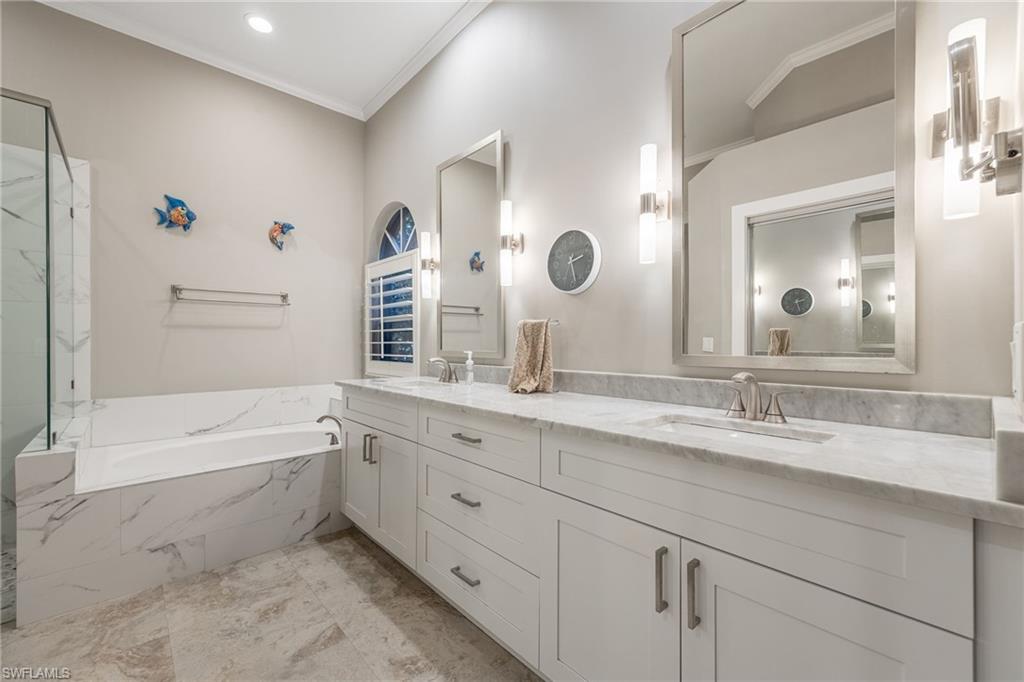 5188 Mabry Drive Naples, FL 34112 - Photo 21 of 49 a bathroom with a granite countertop sink mirror and bathtub