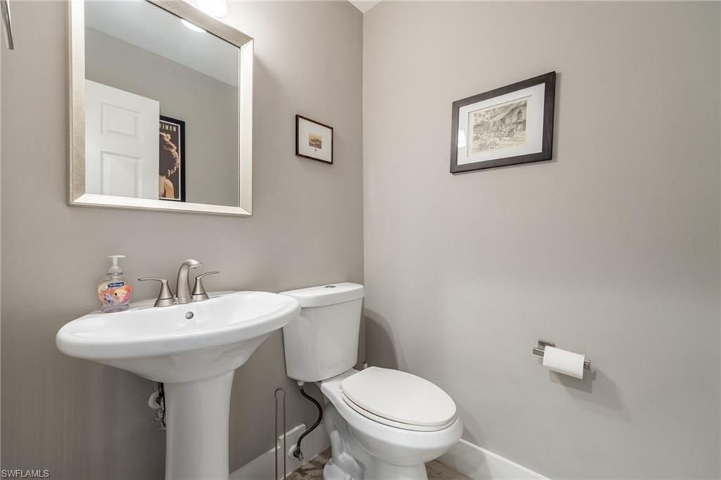5188 Mabry Drive Naples, FL 34112 - Photo 23 of 49 a bathroom with a toilet sink and mirror
