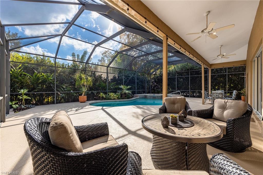 5188 Mabry Drive Naples, FL 34112 - Photo 32 of 49 a outdoor living space with patio furniture and a potted plant