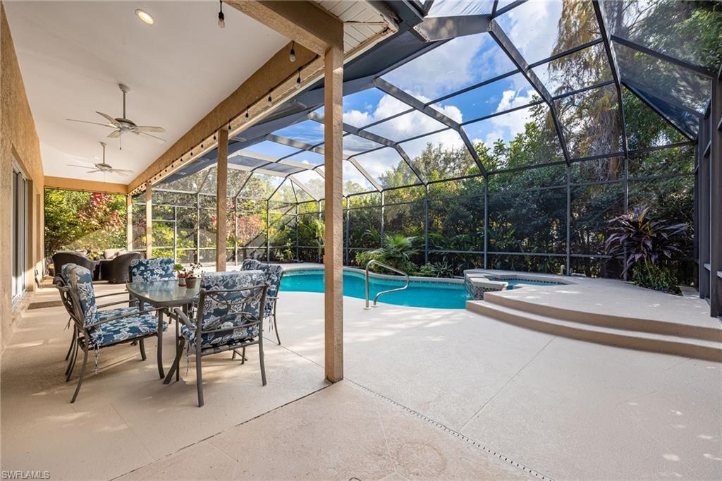 5188 Mabry Drive Naples, FL 34112 - Photo 33 of 49 a view of a patio with a table chairs and a backyard