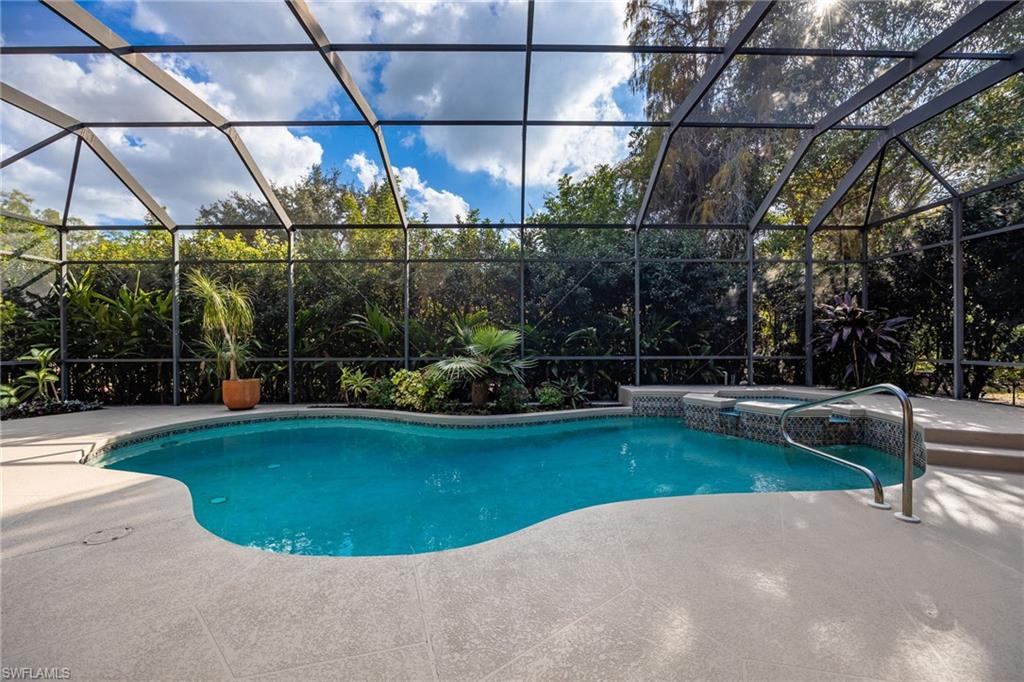 5188 Mabry Drive Naples, FL 34112 - Photo 35 of 49 a view of a swimming pool with a patio and a small yard