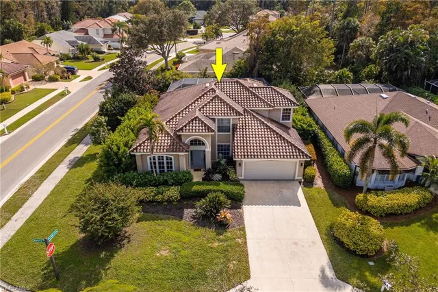 a view of house with garden space and swimming pool