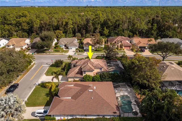 an aerial view of residential houses with outdoor space and swimming pool