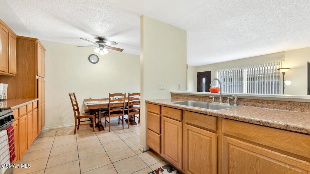 152 Ripley Street Camarillo, CA 93010 - Photo 13 of 36 a dining hall with granite countertop a sink a stove dining table and chairs