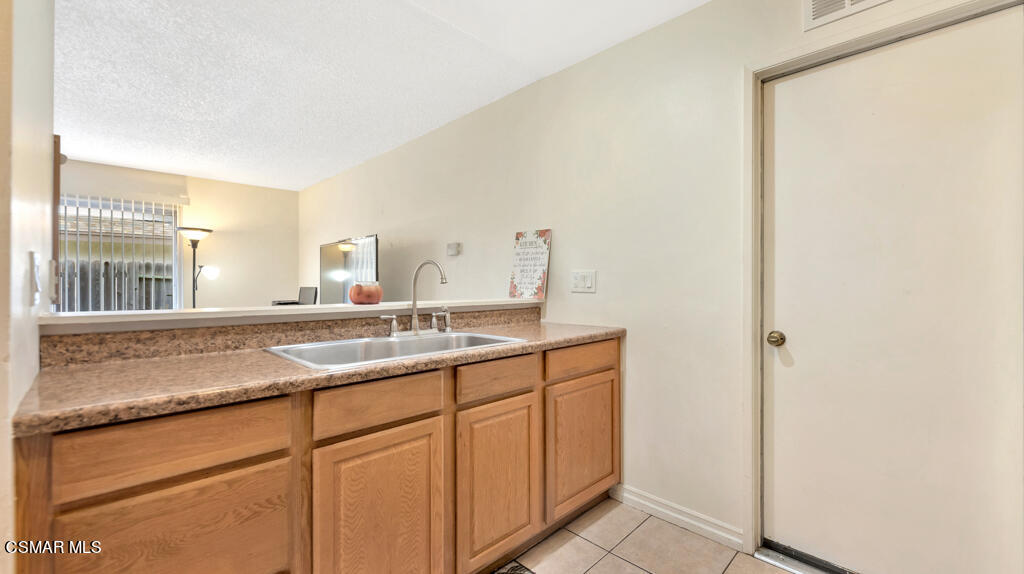 152 Ripley Street Camarillo, CA 93010 - Photo 18 of 36 a bathroom with a granite countertop sink and a mirror