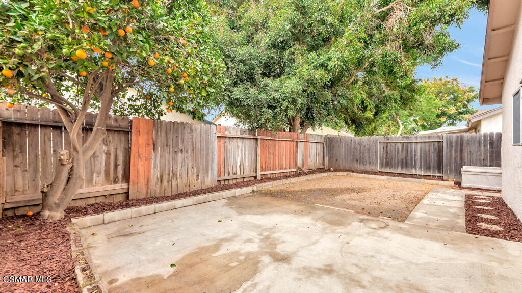 152 Ripley Street Camarillo, CA 93010 - Photo 23 of 36 a view of a backyard with wooden fence and a large tree
