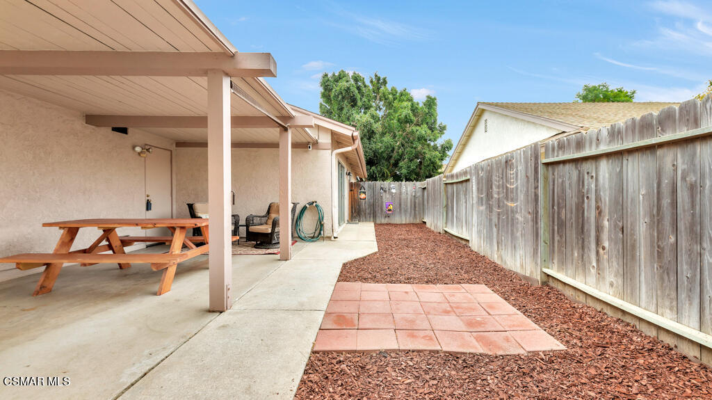 152 Ripley Street Camarillo, CA 93010 - Photo 31 of 36 a view of a patio with table and chairs with wooden fence and plants