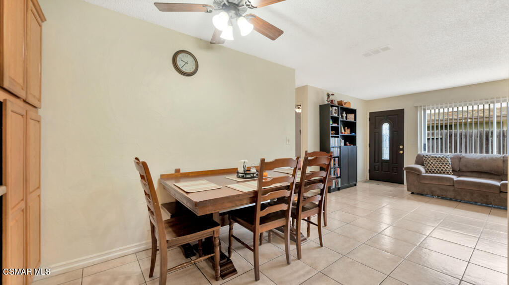 152 Ripley Street Camarillo, CA 93010 - Photo 9 of 36 a view of a dining room with furniture and a floor to ceiling window