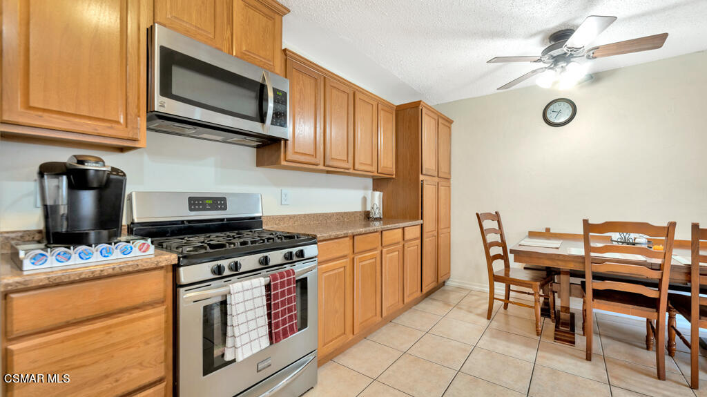 152 Ripley Street Camarillo, CA 93010 - Photo 10 of 36 a kitchen with stainless steel appliances granite countertop a stove a sink dishwasher and a microwave oven with cabinets