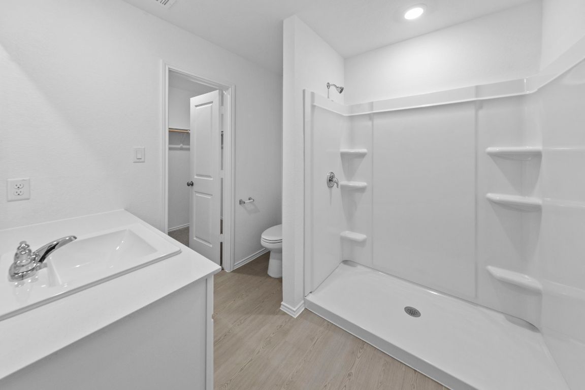 245 Ammolite Lane Maxwell, TX 78656 - Photo 14 of 17 a bathroom with a sink a toilet and shower