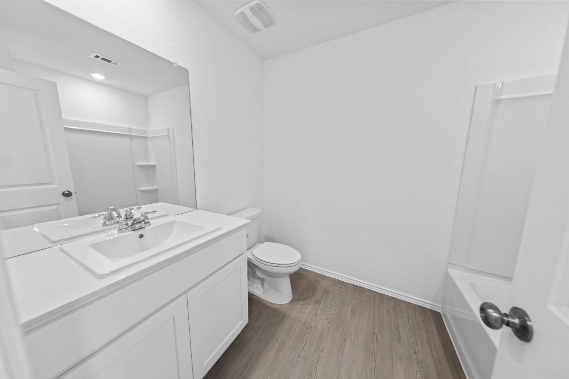 245 Ammolite Lane Maxwell, TX 78656 - Photo 4 of 17 a bathroom with a sink a toilet and mirror