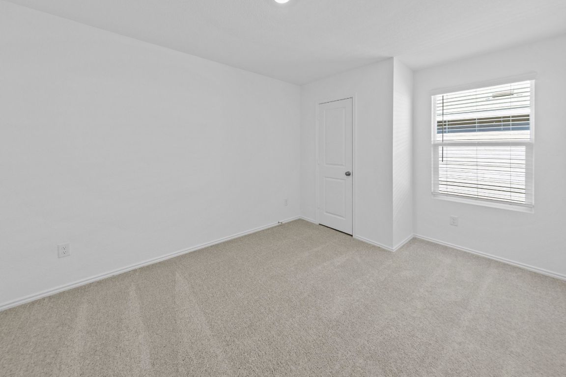 245 Ammolite Lane Maxwell, TX 78656 - Photo 7 of 17 a view of an empty room and a window