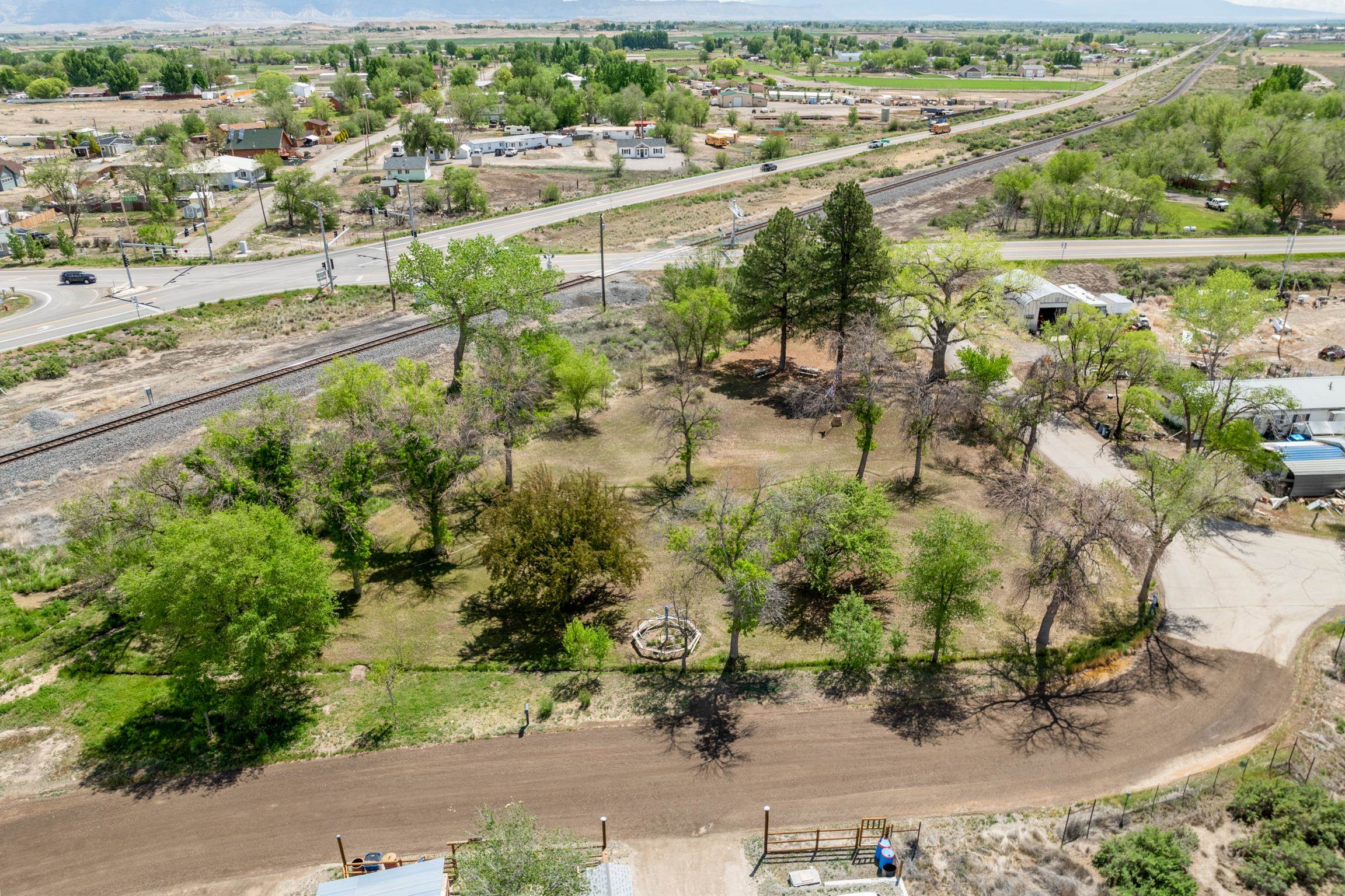 1296 M 1/4 Road Loma, CO 81524 - Photo 2 of 32 an aerial view of residential houses with outdoor space and trees