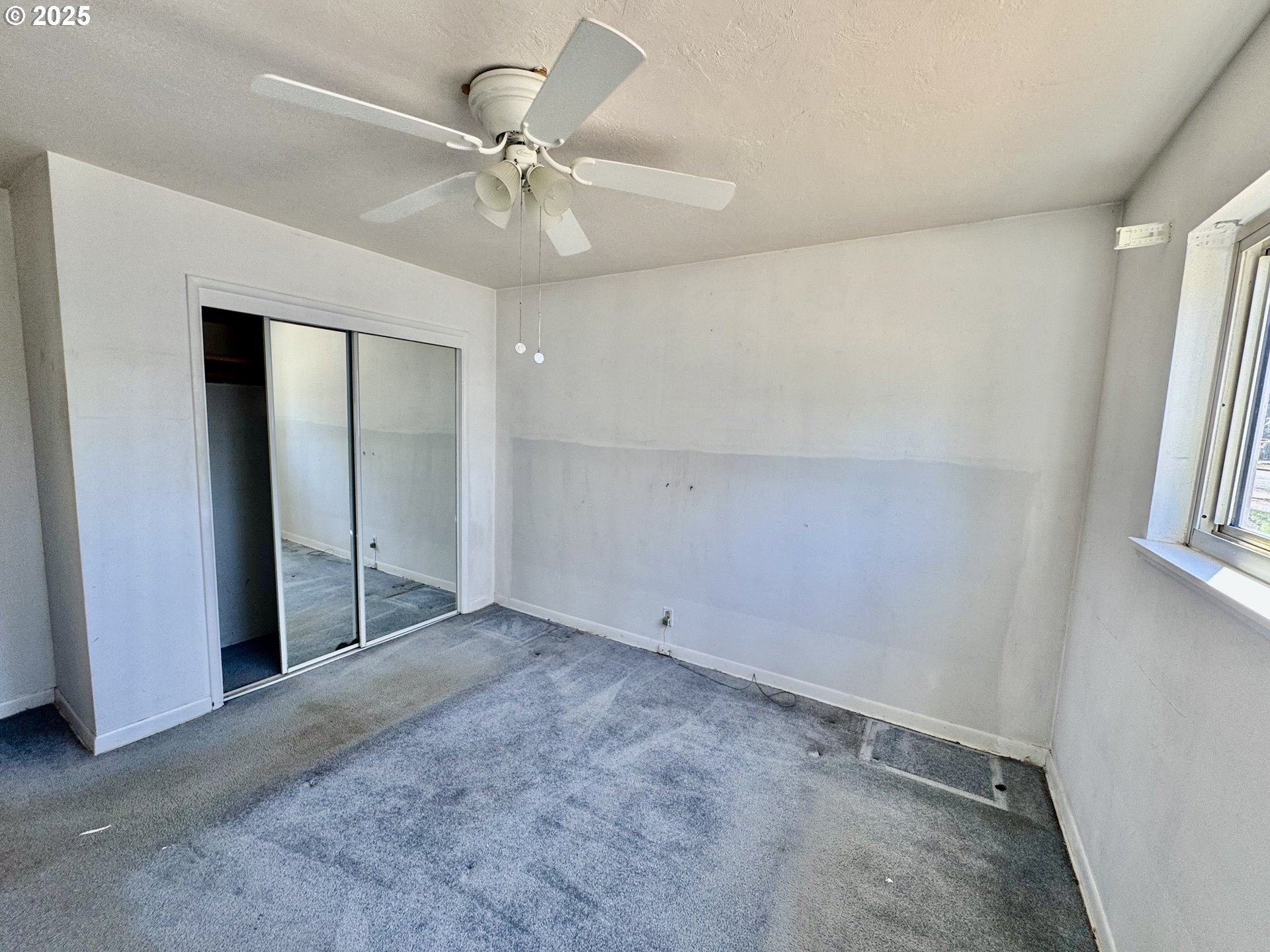 1915 Carter Lane Springfield, OR 97477 - Photo 11 of 30 an empty room with a ceiling fan and a window