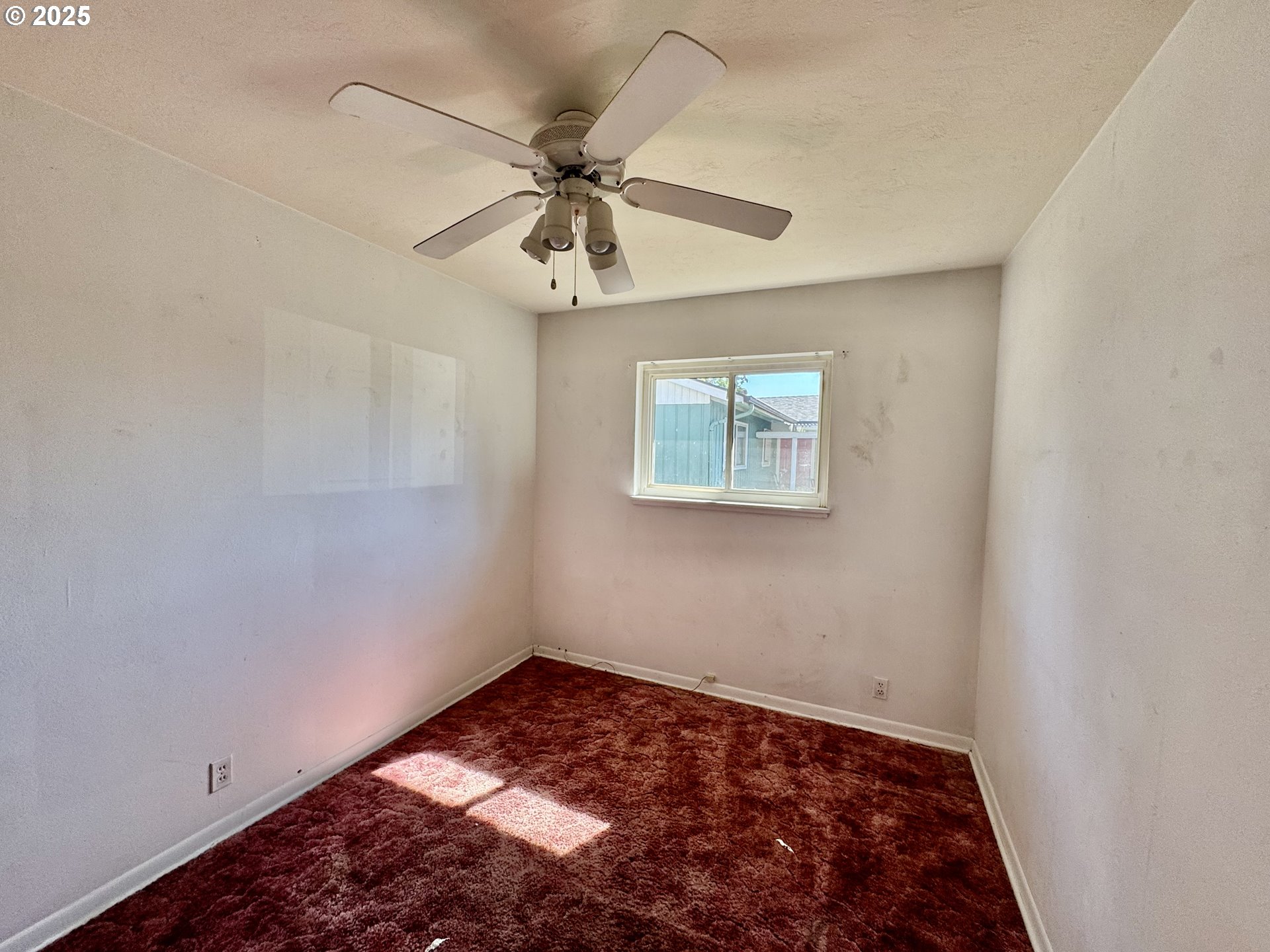 1915 Carter Lane Springfield, OR 97477 - Photo 12 of 30 an empty room with windows and fan