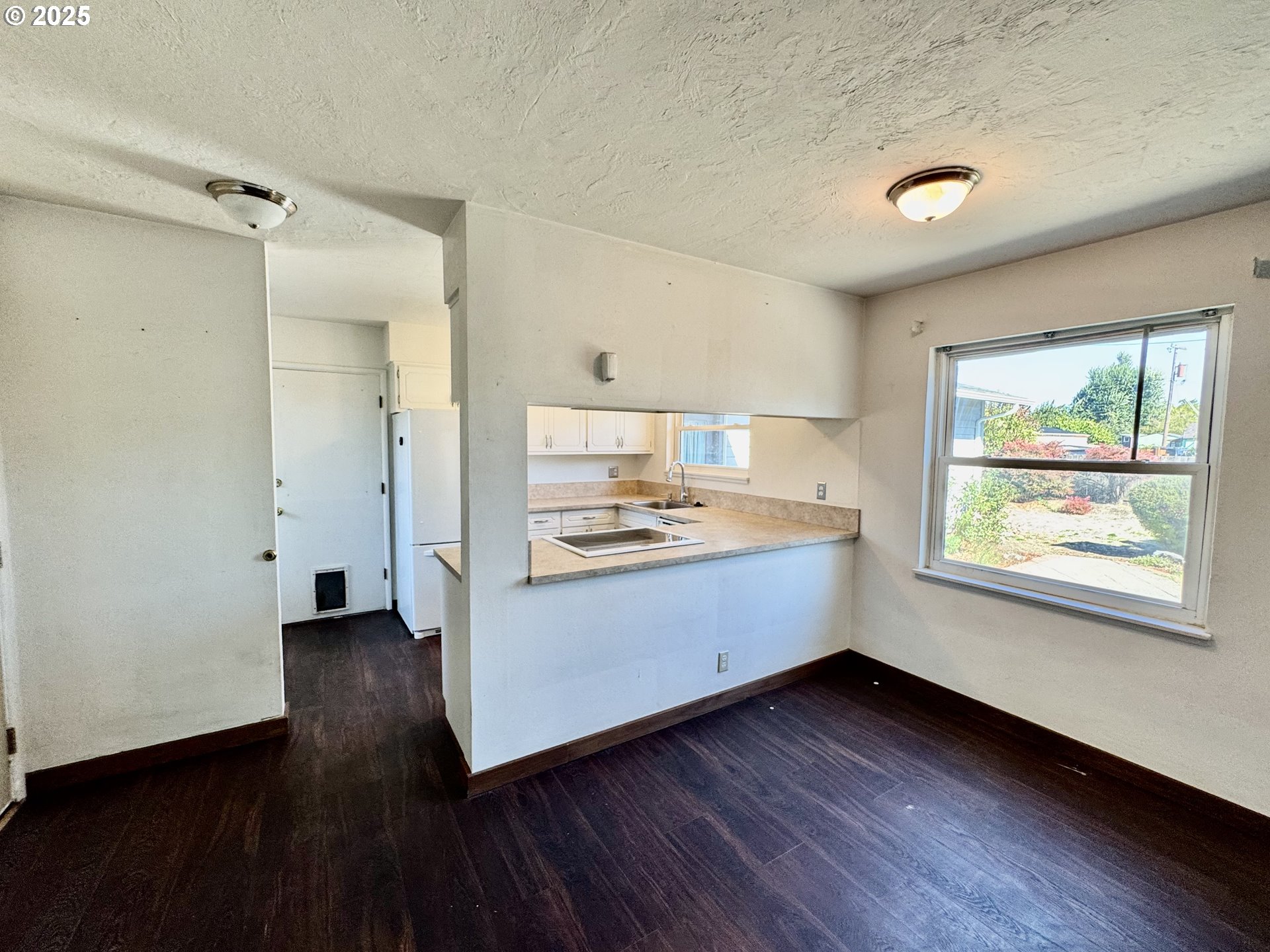 1915 Carter Lane Springfield, OR 97477 - Photo 15 of 30 a kitchen with wooden floors and white walls