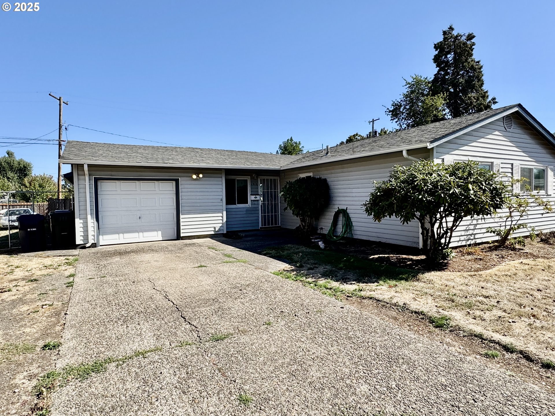 1915 Carter Lane Springfield, OR 97477 - Photo 2 of 30 a front view of a house with a yard and garage