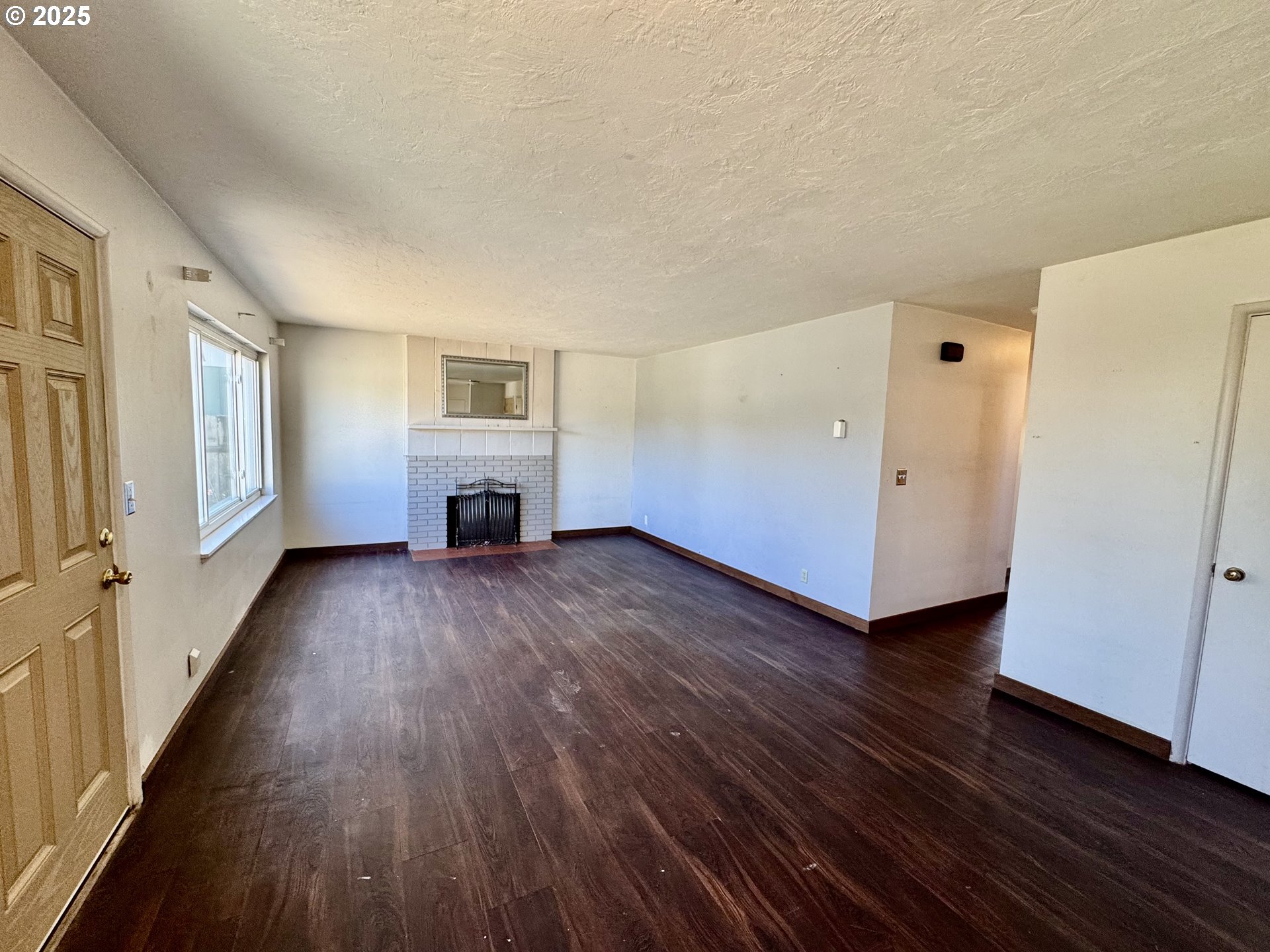 1915 Carter Lane Springfield, OR 97477 - Photo 26 of 30 a view of a livingroom with wooden floor and a ceiling fan