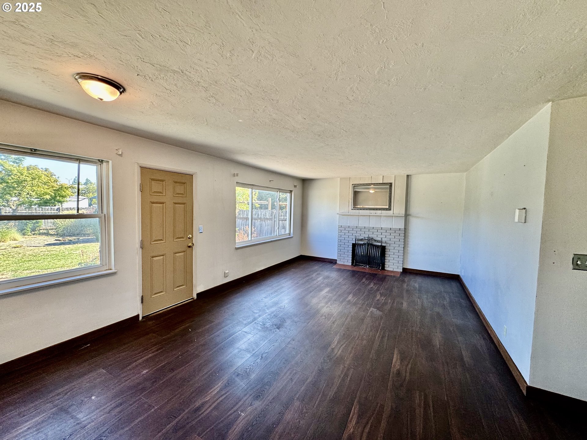 1915 Carter Lane Springfield, OR 97477 - Photo 4 of 30 a view of an empty room with a window and wooden floor