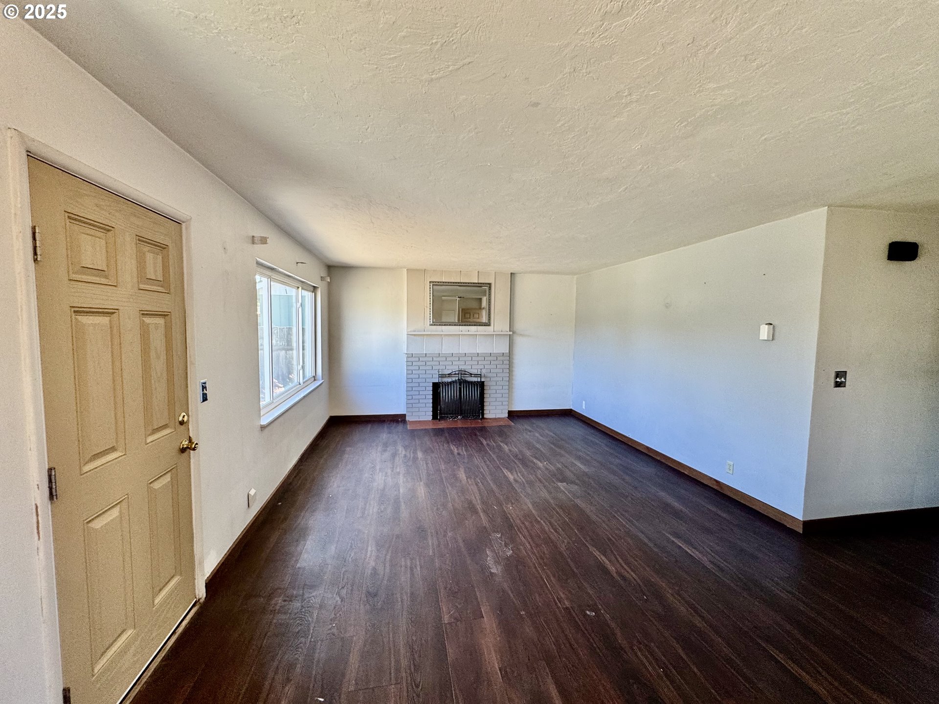 1915 Carter Lane Springfield, OR 97477 - Photo 5 of 30 wooden floor in an empty room with a fireplace