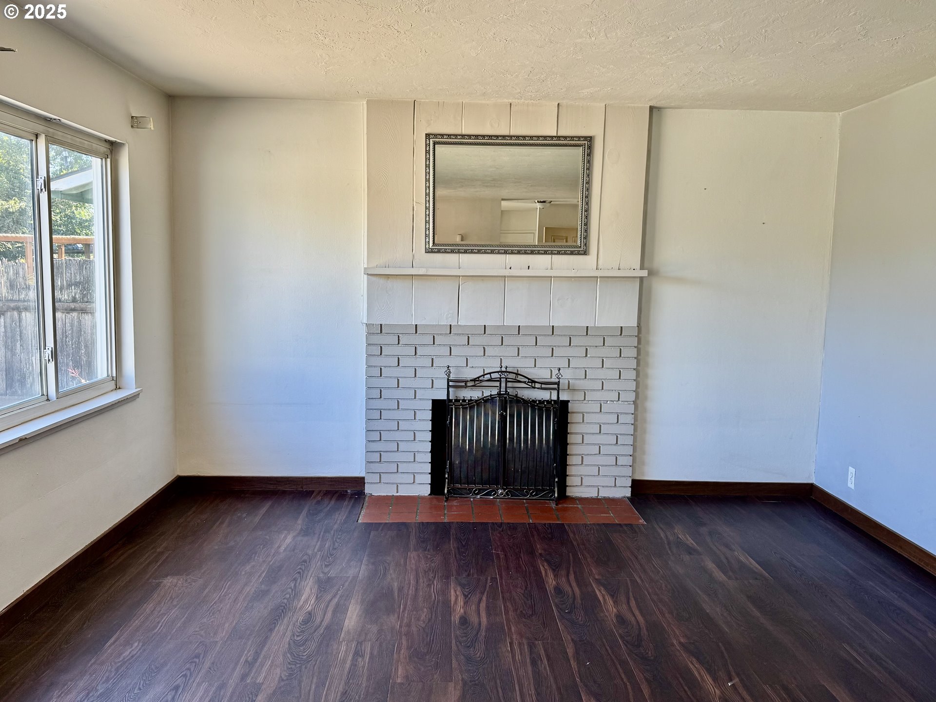1915 Carter Lane Springfield, OR 97477 - Photo 6 of 30 a view of a livingroom with wooden floor and a fireplace