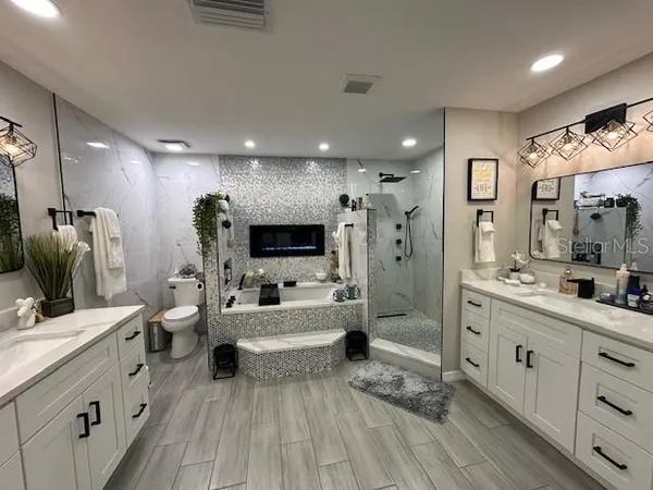 a large room with a lot of counter space and wooden floor