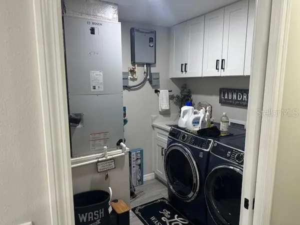 a view of storage and utility room with washer and dryer