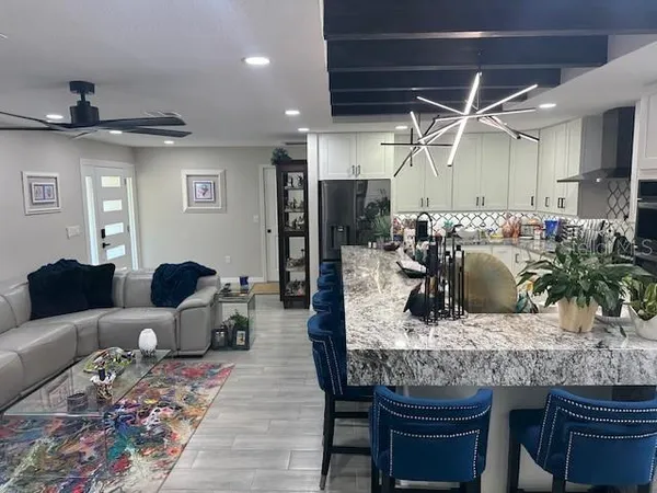a living room with furniture and a chandelier