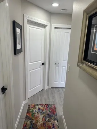 a room with a walk in closet and a mirror