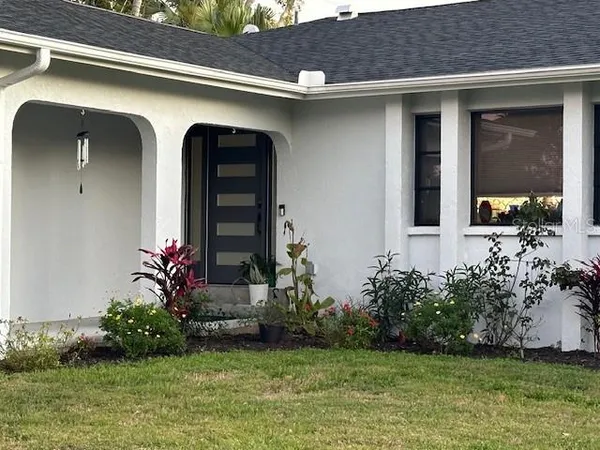 a front view of a house with garden