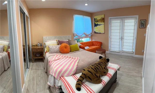 a bedroom with two beds and painting on the wall