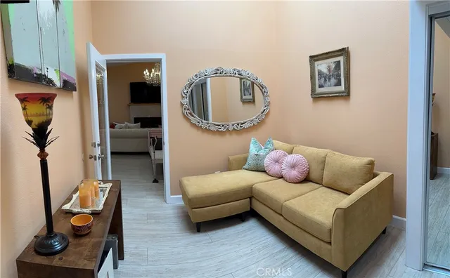 a living room with furniture and a mirror