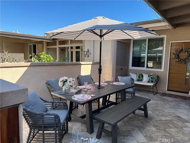 a view of a patio with table and chairs and potted plants