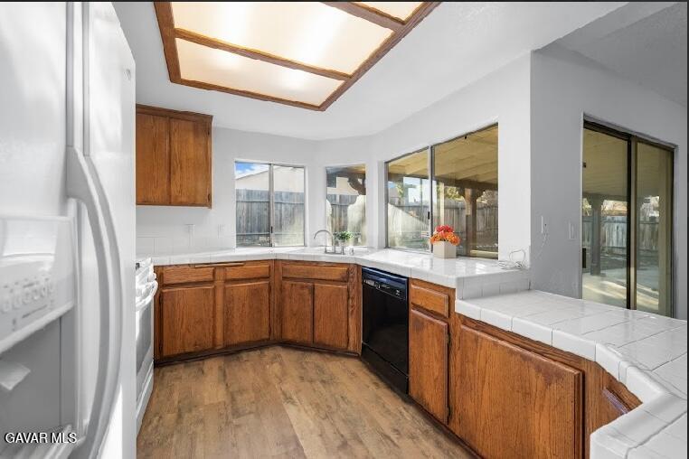 2852 San Ramon Drive Lancaster, CA 93535 - Photo 12 of 32 a large kitchen with stainless steel appliances granite countertop a sink and wooden cabinets