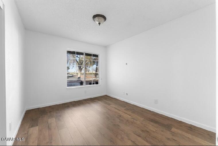 2852 San Ramon Drive Lancaster, CA 93535 - Photo 16 of 32 an empty room with wooden floor and windows