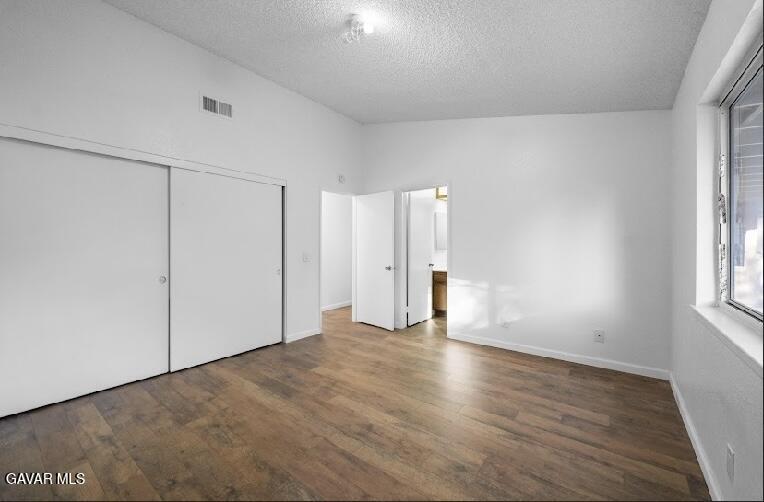 2852 San Ramon Drive Lancaster, CA 93535 - Photo 19 of 32 a view of an empty room with wooden floor and a window
