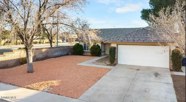 a view of a backyard with large trees