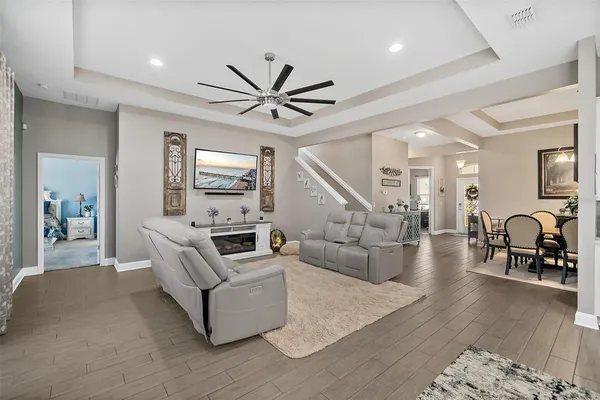 a kitchen with white cabinets stainless steel appliances and a wooden floor