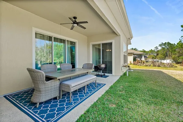 a backyard of a house with table and chairs